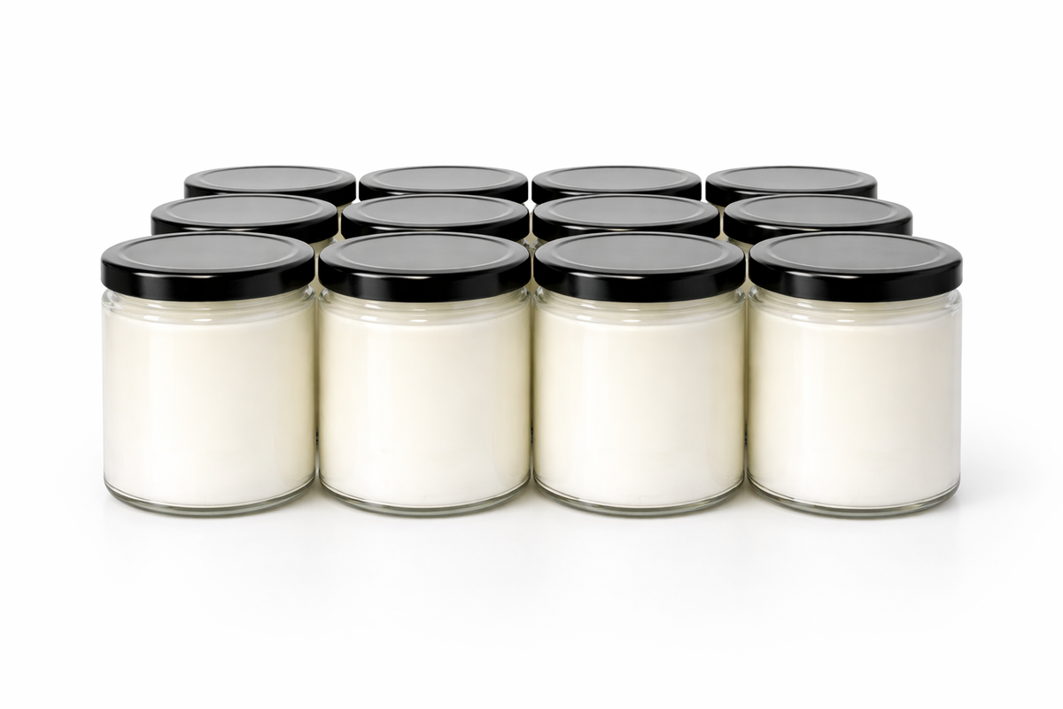Unlabeled wholesale candles in clear glass jars with black lids, ready for custom branding. 9 Oz Salsa Jar Candles.