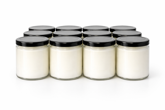 Unlabeled wholesale candles in clear glass jars with black lids, ready for custom branding. 9 Oz Salsa Jar Candles.